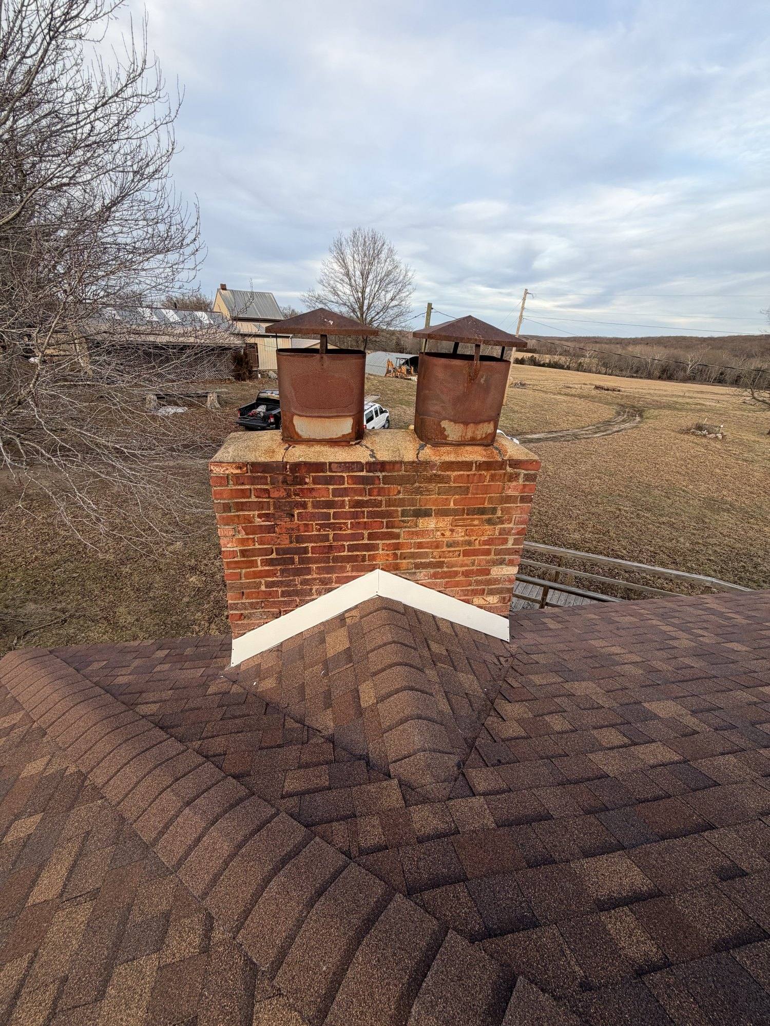 Brick chimney detail on a recently re-roofed rural Pettis County home