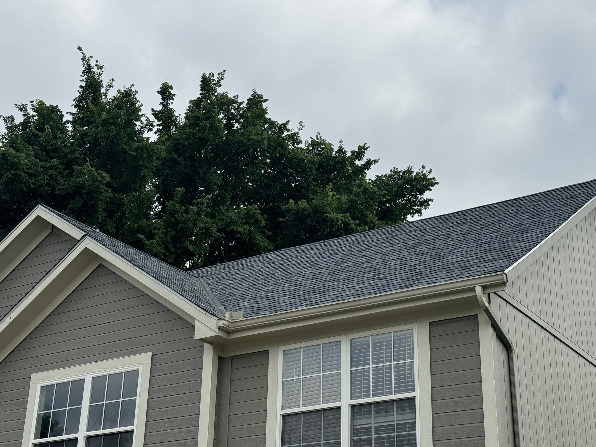 Two-story craftsman home in Sedalia with steep peaked roofline against a blue sky
